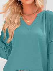 Elegant smocked long sleeve blouse in Lake Green polyester with V-neck and textured fabric.