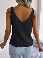 Black cable knit diamond vest top with V-neck and ribbed hem.