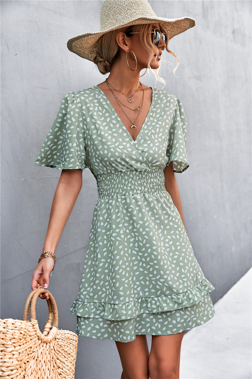 Gum Leaf smocked waist mini dress with flutter sleeves and ruffle hem, featuring a white speckle print.