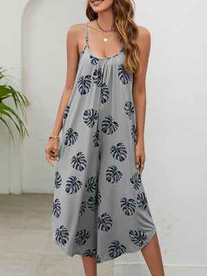 Gray Dawn jumpsuit with monstera print, gathered bust, spaghetti straps, and culotte legs.