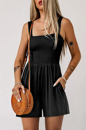 Black smocked bodice romper with square neckline and pockets, styled with a crossbody bag.