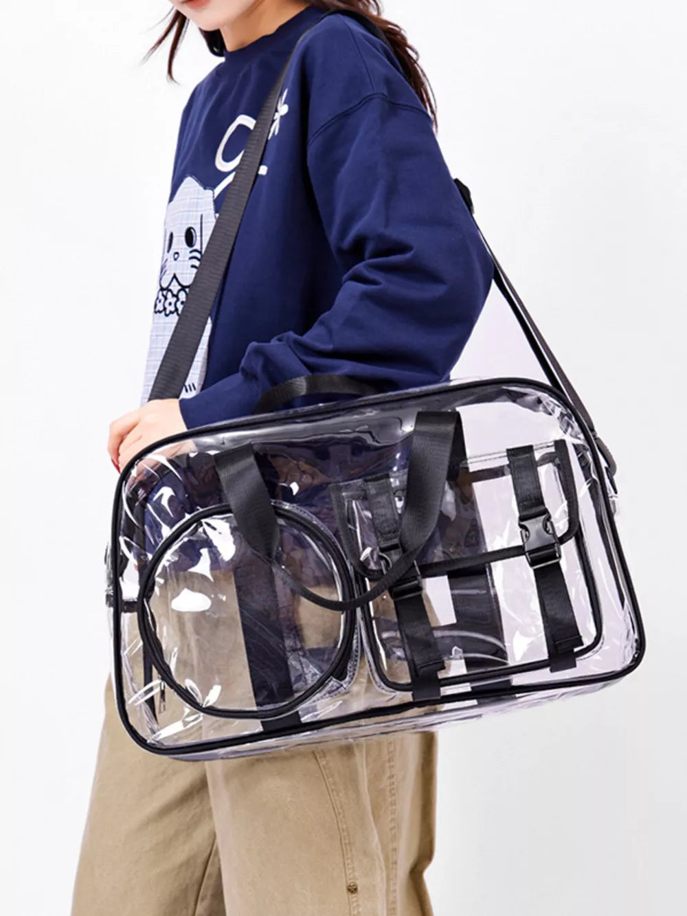 Chic clear PVC travel bag with pink accents and adjustable strap.