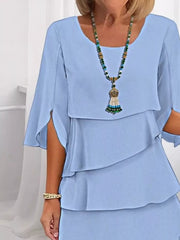 Light blue ruffled layered dress with flutter sleeves and a scoop neckline.