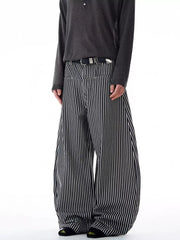 Men's black and white striped wide-leg sweatpants with a black belt.