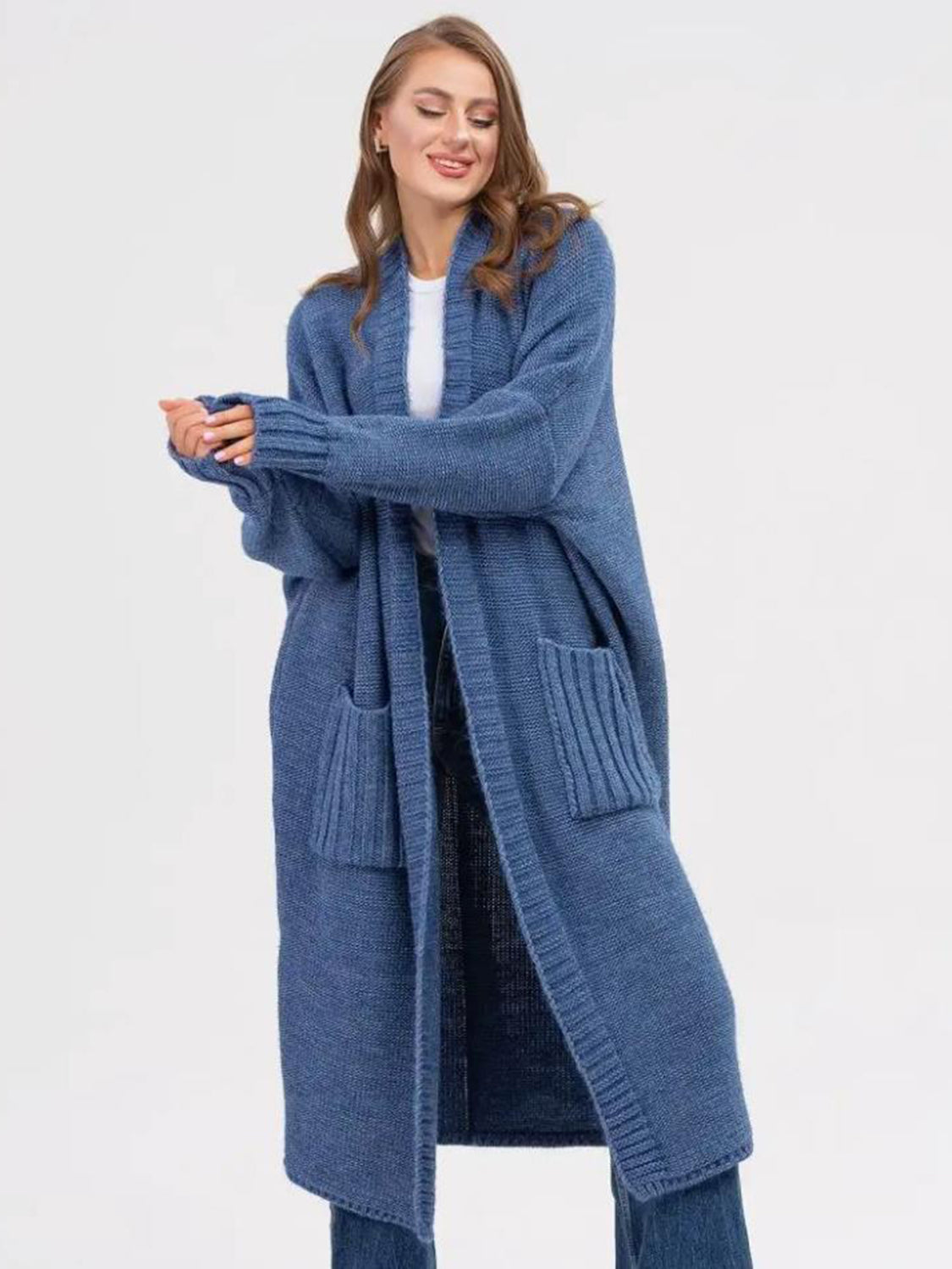 Dusty blue acrylic knit oversized cocoon cardigan with pockets and ribbed cuffs.