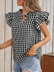 Black and white gingham blouse with ruffle sleeves and a mock neckline.