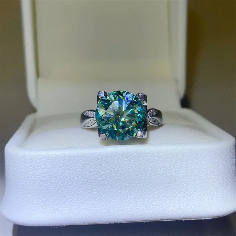 Silver ring with large green moissanite solitaire and pavé accents.