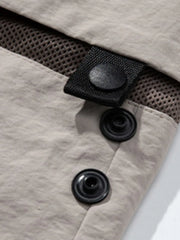 Gray convertible utility pants with snap closures and mesh detail