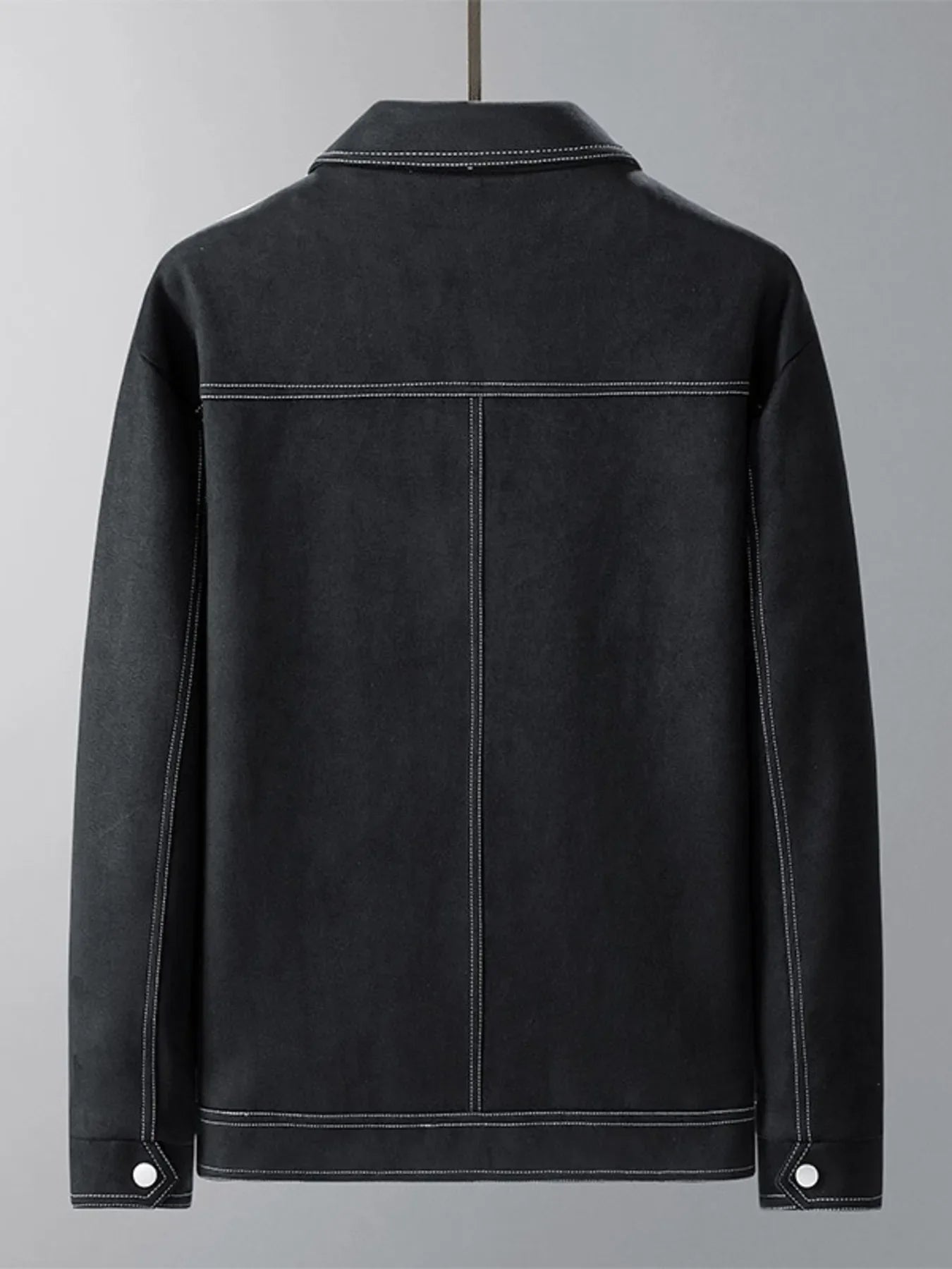 Black trucker jacket with contrast stitching and snap cuff