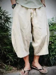 Off-white relaxed fit cropped sweatpants with drawstring waist and pockets.