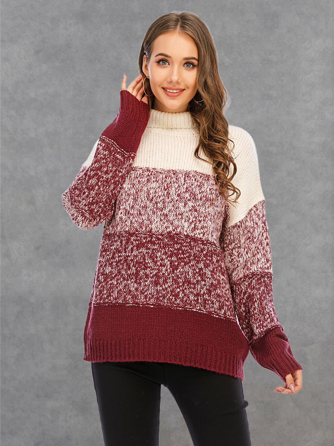Colorblock knit turtleneck sweater in cream and wine with defined panels and textured acrylic yarn.