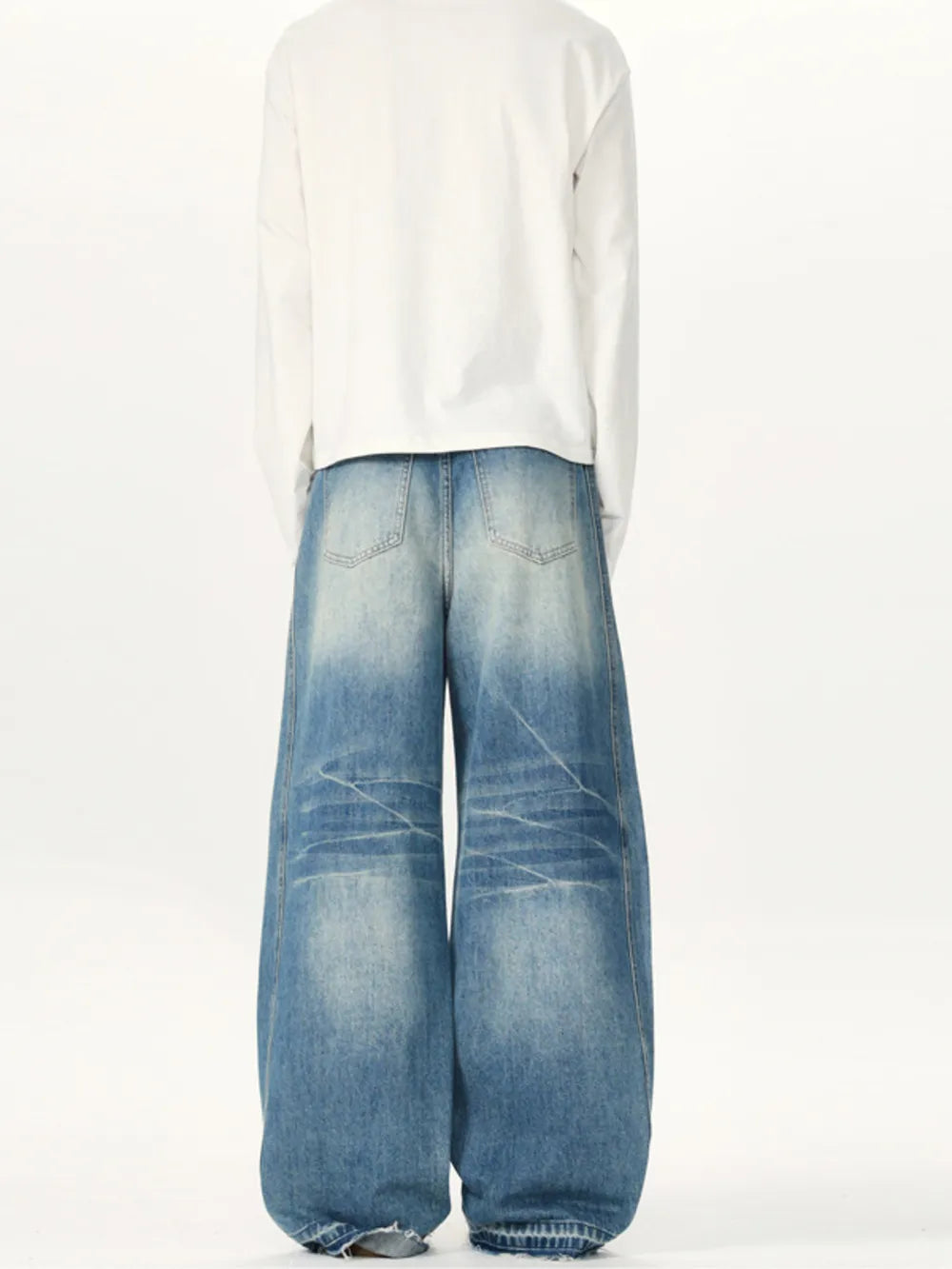 Relaxed fit washed cotton jeans in light blue with baggy legs and distressed details.