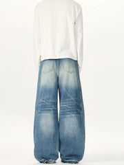 Relaxed fit washed cotton jeans in light blue with baggy legs and distressed details.