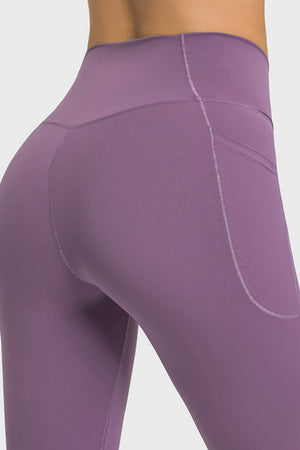 Purple performance leggings with pockets and sculpted waistband detail