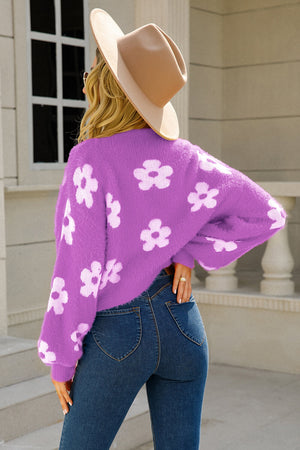 Purple fuzzy cropped cardigan with white floral pattern, long sleeves, crew neck.