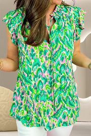 Green abstract print cap-sleeve blouse with ruffled neckline and tie detail
