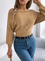 Camel cable knit off-shoulder crop sweater with diamond pattern detail.