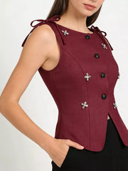 Burgundy tie-shoulder vest with button front and floral appliqu detail.