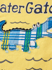 Later Gator toddler graphic tee in yellow with a blue and green plaid alligator applique and wavy water details.