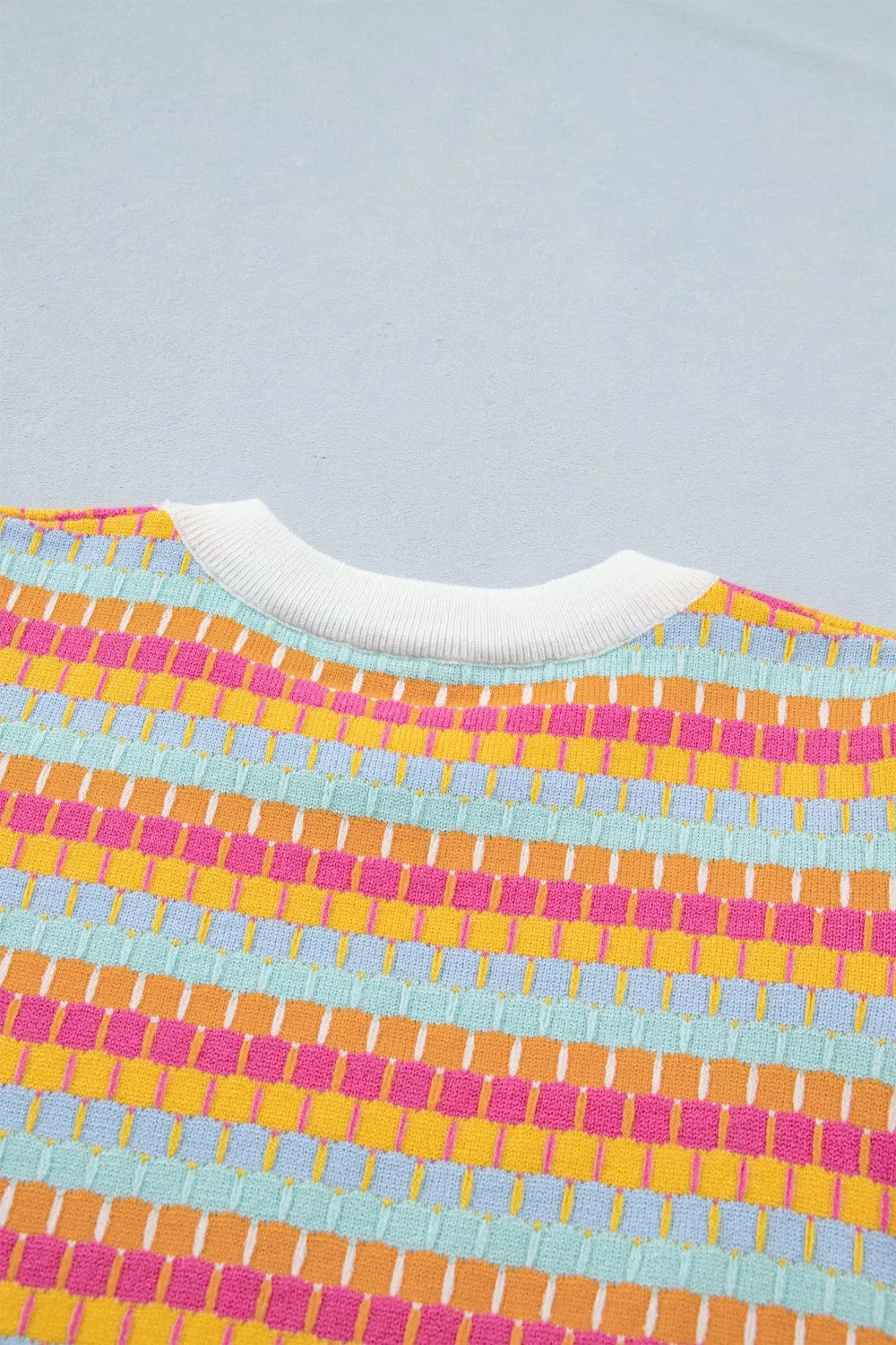 Vibrant abstract knit sweater with crew neck and ribbed trim in colorful stripes.