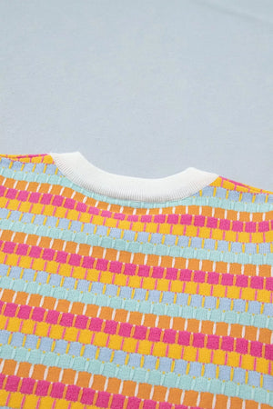 Vibrant abstract knit sweater with crew neck and ribbed trim in colorful stripes.