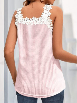 Blush pink waffle knit tank top with white daisy trim neckline and straps.