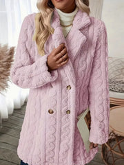 Pink faux shearling double-breasted coat with cable knit texture and button closure.