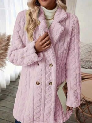 Pink faux shearling double-breasted coat with cable knit texture and button closure.