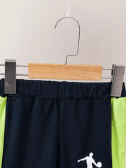 Navy baby shorts with neon green side stripes and basketball graphic.