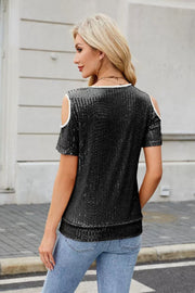 Black sequin cold shoulder blouse with white trim and short sleeves.