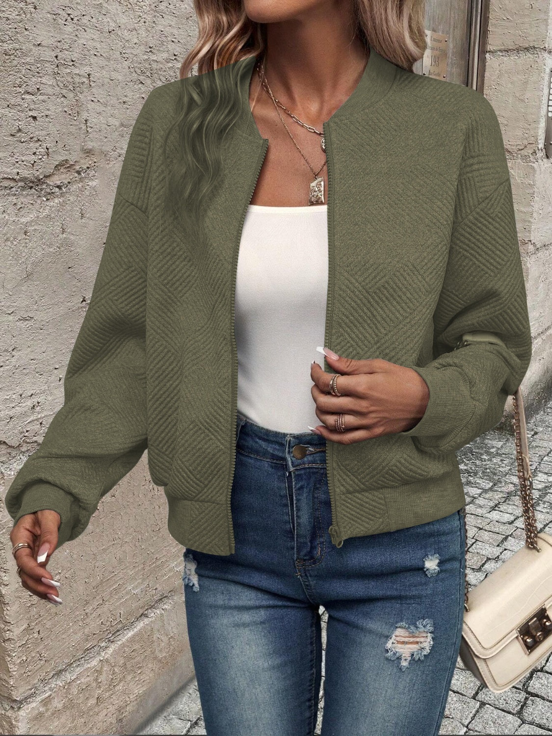 Army green geometric quilted bomber jacket with a zip front and ribbed cuffs.