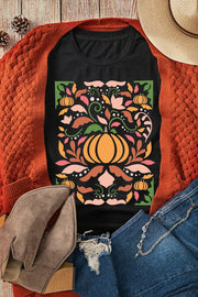 Black t-shirt with a colorful botanical pumpkin graphic, autumn leaves, and floral accents.