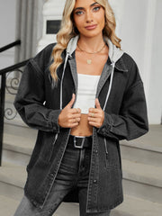 Black oversized denim jacket with hood and button front, styled with a white crop top and jeans.
