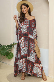 Patchwork caftan maxi dress in mixed floral prints and deep red, with a v-neck and wide sleeves.