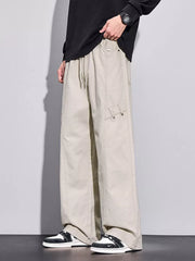 Men's loose-fit apricot sweatpants with drawstring and cargo pocket detail.