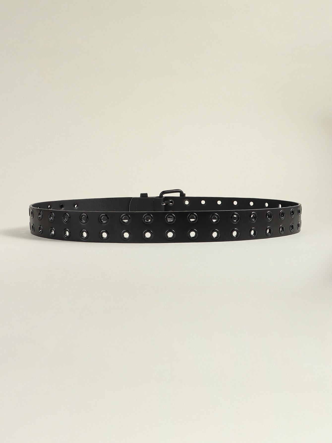 Black vegan leather belt with double row of silver grommets and silver buckle.