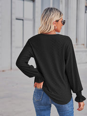 Black eyelet lace inset blouson sleeve top with ruffled cuffs.