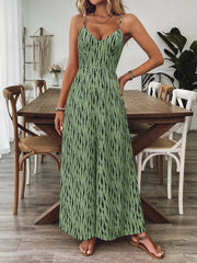 Matcha green wide-leg jumpsuit with black vertical dash print, V-neck, spaghetti straps.