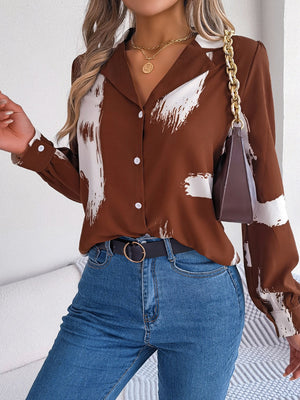 Brown brushstroke print collared blouse with white abstract strokes, button front, and long sleeves.