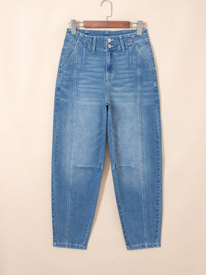 High-waisted blue denim barrel jeans with cuffed hems and front seam detail.