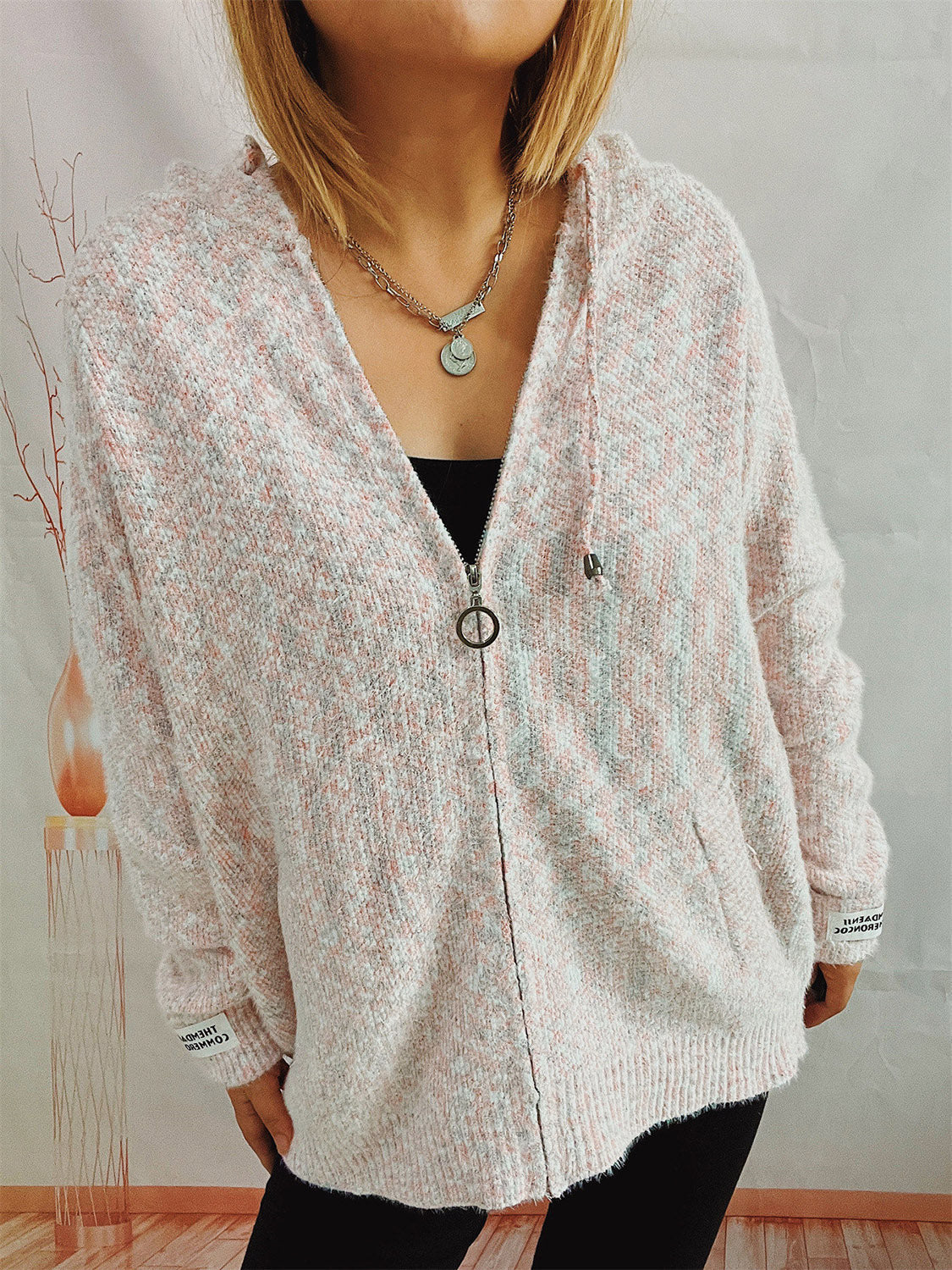 Speckled knit relaxed zip-up hoodie in blush pink with a ring zipper and pockets.