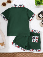 Baby polo shirt and shorts set in dark green with camouflage collar and trim.