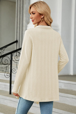 Cream textured knit cardigan with long sleeves and asymmetrical hem.