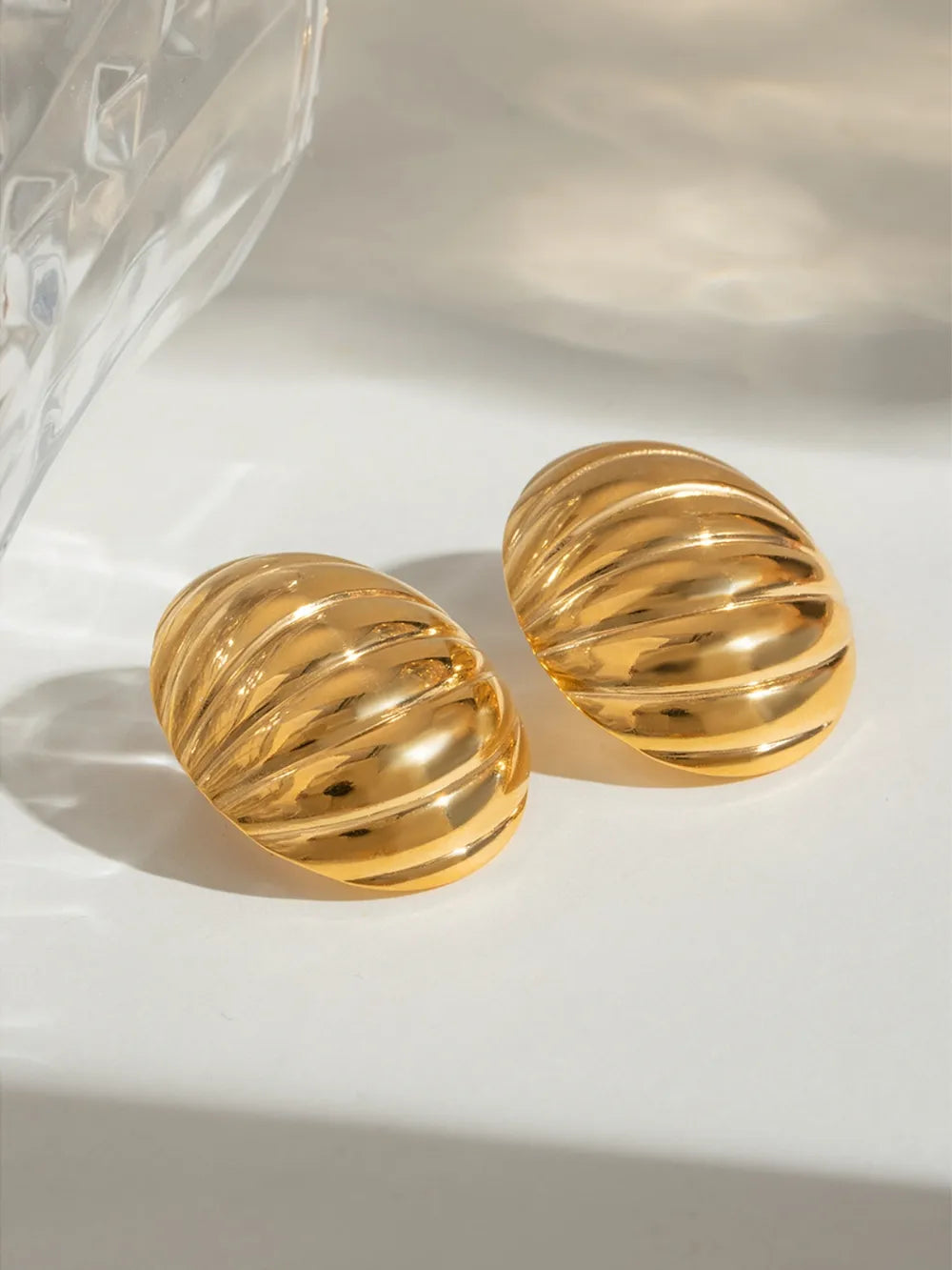 Gold dome earrings with ribbed texture, 18K gold-plated.