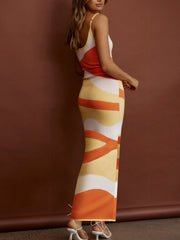 Geometric knit maxi slip dress in orange, yellow, and white abstract print.