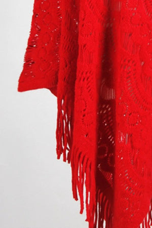 Scarlet knit poncho with open crochet pattern and fringe detail