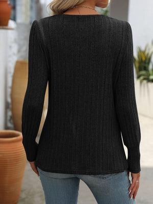 Black ribbed knit top with side button detail and long sleeves