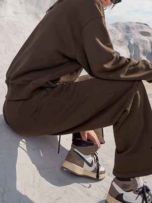 Brown seamed sweatshirt and wide-leg lounge pants set with visible stitching detail.