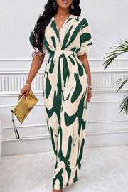 Abstract brushstroke wide-leg jumpsuit in cream and dark green with short sleeves and a V-neck.