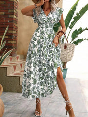 Botanical print midi dress with ruffle sleeves, V-neck, and tiered skirt in white with green pattern.